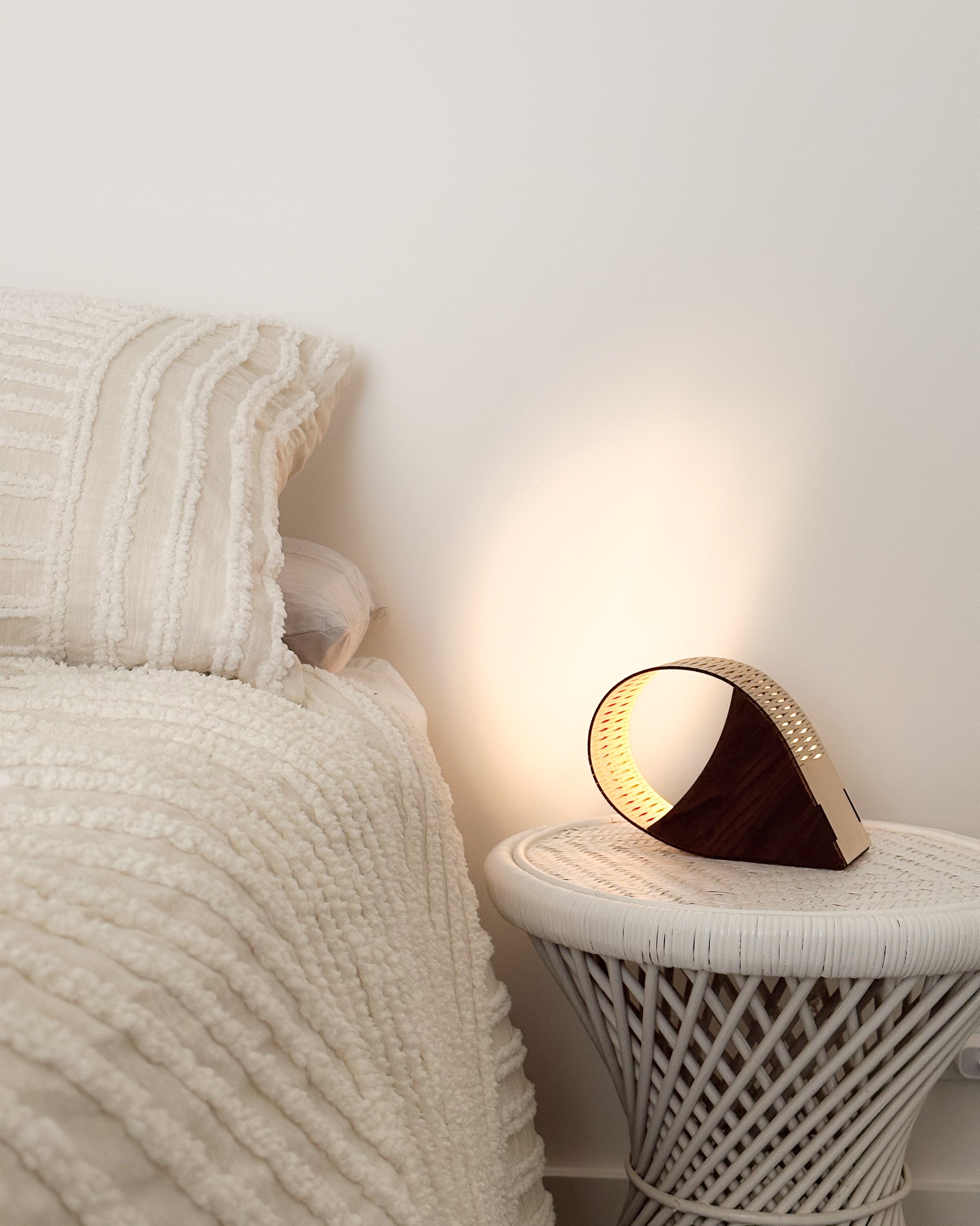 droplet lamp on wicker bedside table