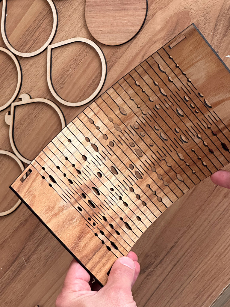 Wooden laser-cut shapes on a wooden surface