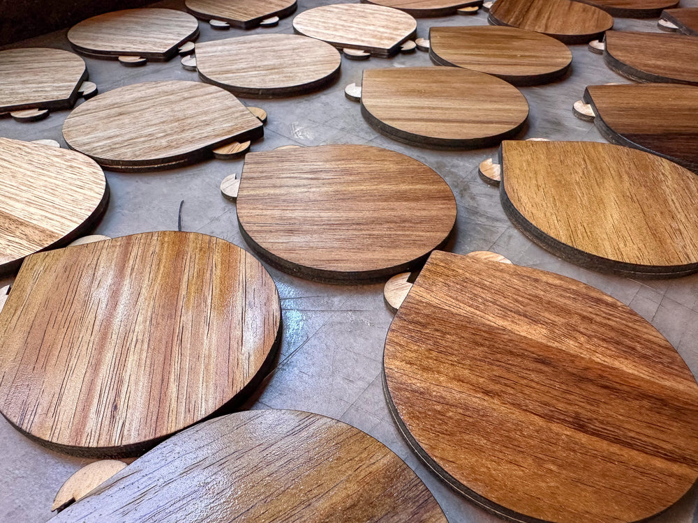 Wooden tops oiled and arranged on a workshop bench