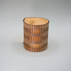 Wooden lamp with a radiant design on a gray background