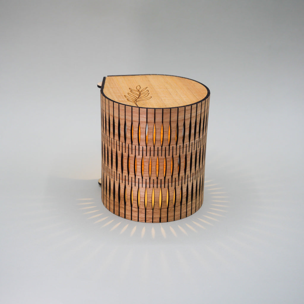 Wooden lamp with a radiant design on a gray background