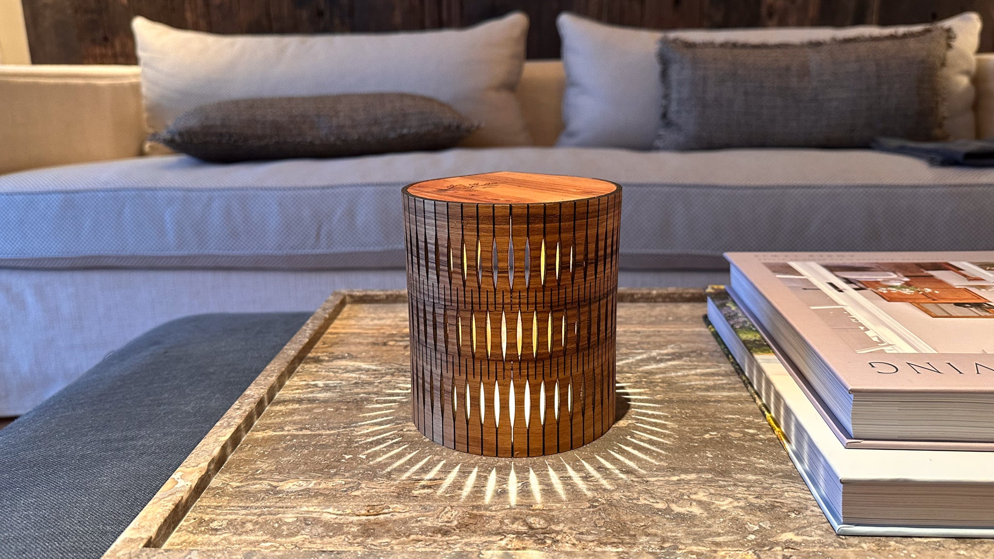Wooden lamp on a coffee table with books in a living room setting