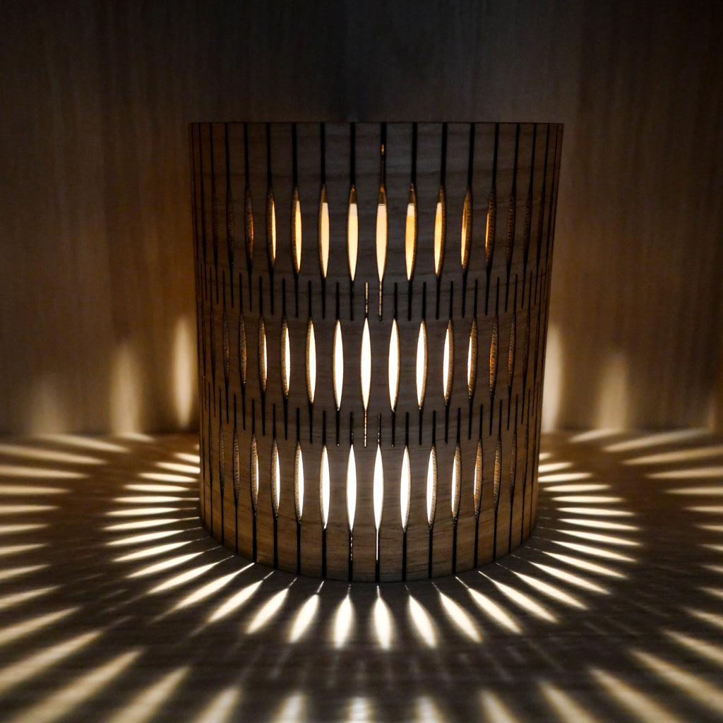 Timber Bubble Lamp with crafted apertures project a rhythmic halo of light and shadow