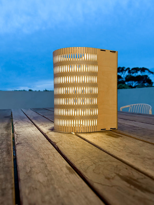 Droplet Cordless Lamp Tall in Natural timber on outdoor table upright