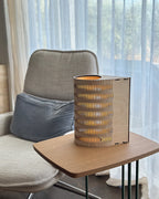 Tall Droplet Lamp: wooden cylindrical slatted design with warm glow