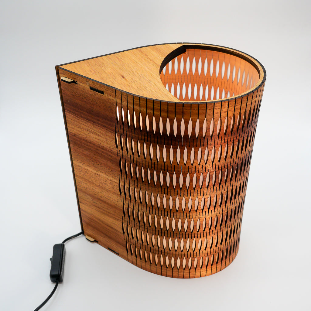Tall Droplet Lamp: wooden spiral with intricate cut-outs and black cord