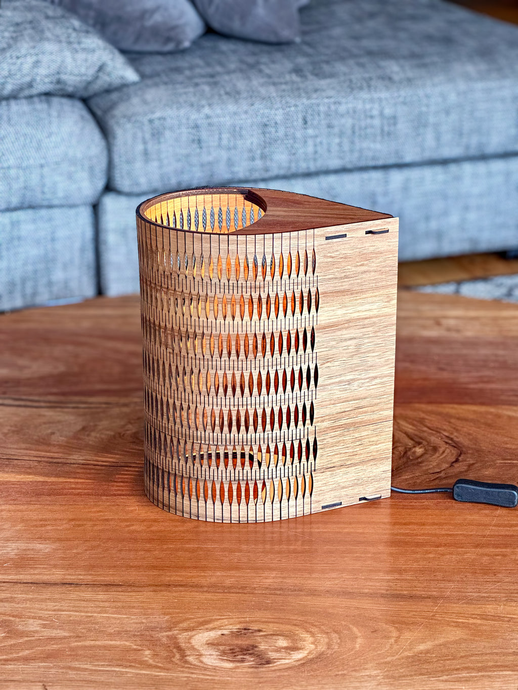 Tall Droplet Lamp in Blackwood timber: wooden cylindrical slatted design with warm glow