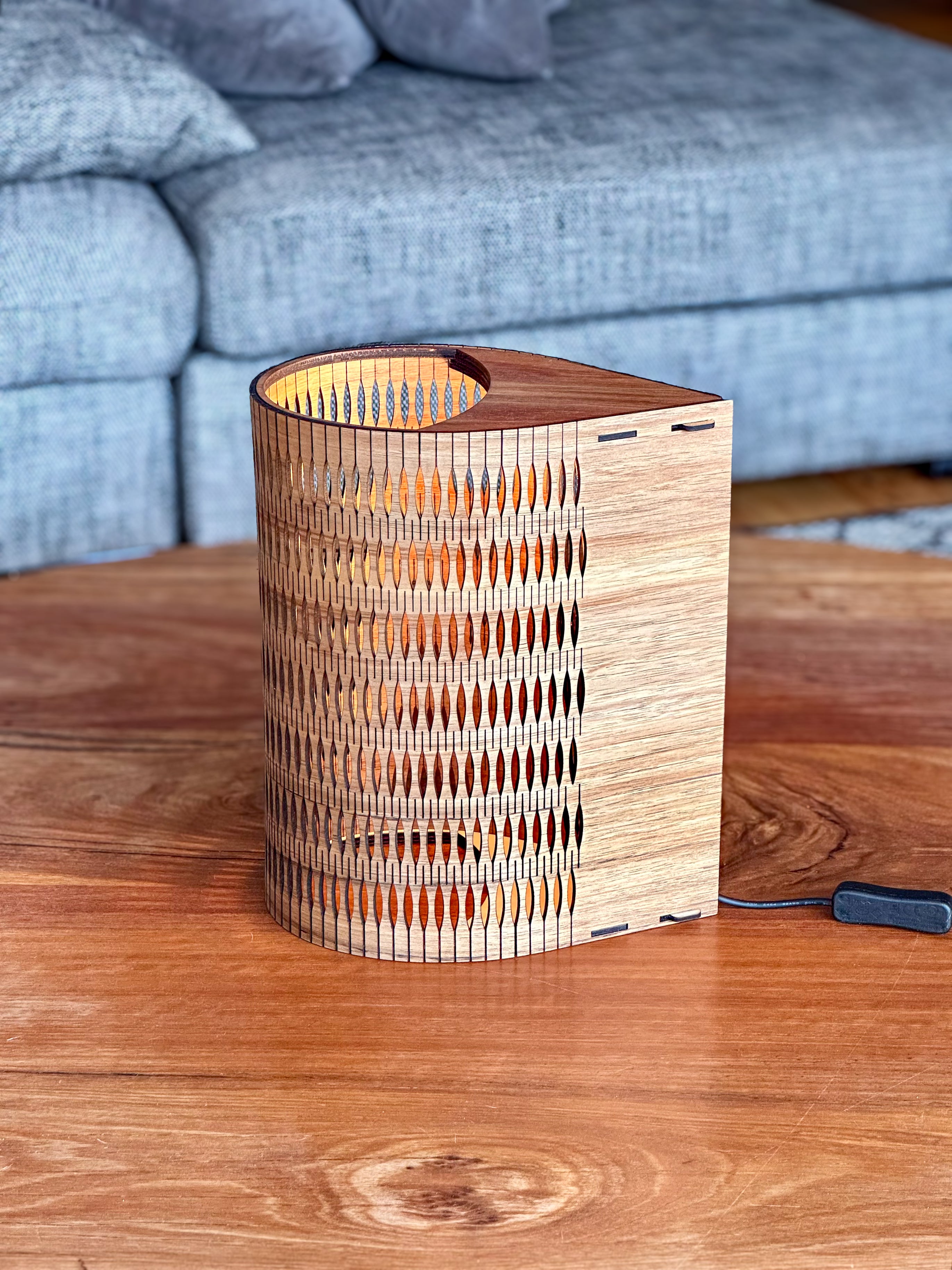 Tall Droplet Lamp in Blackwood timber: wooden cylindrical slatted design with warm glow